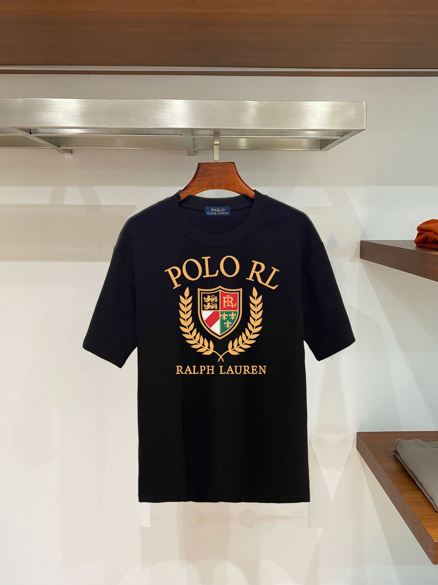 26081217-Ralph-Lauren-Tee-61 Ralph Lauren Polo RL Laurel Wreath Shield Crest Graphic T‑Shirt In Black - Image 1