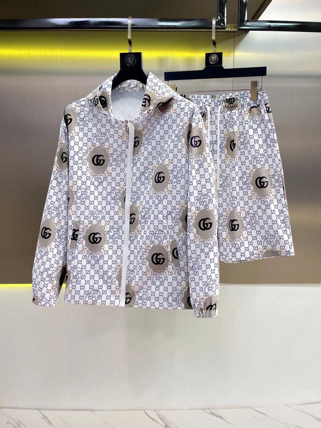 26081702-Gucci-Outfit-240-01 Gucci Men White All‑Over Monogram Print Hooded Zip‑Up Jacket & Drawstring Shorts 2pcs Set - Image 1